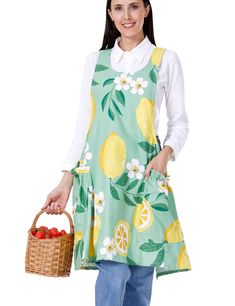 a woman wearing an apron holding a basket of fruit