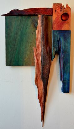 two pieces of wood are hanging on the wall