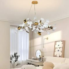 a living room filled with furniture and a chandelier hanging over the top of it