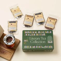 teas and other items on a wooden tray next to a card board with the words library tea collection