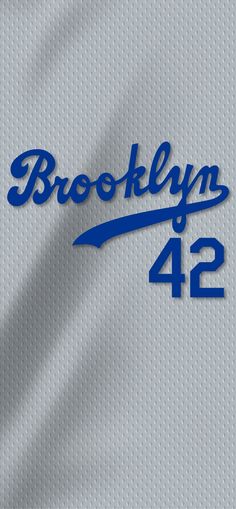 the brooklyn 4 / 2 logo is shown in blue on a gray jersey with white stitching