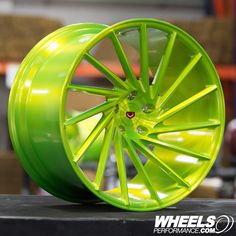 a bright green wheel on display in a shop