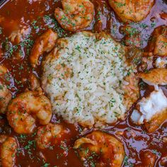 some shrimp and rice are in a red sauce