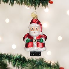 a santa clause ornament hanging from a christmas tree