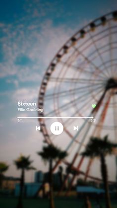 an image of a ferris wheel in the sky with music player on it's screen