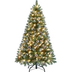 a white christmas tree with lights and pine cones on the top, in a black stand