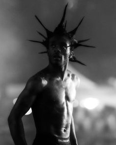 a shirtless man with spiked hair on his head