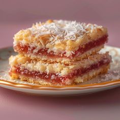 three pieces of dessert sitting on top of a white and orange plate next to each other