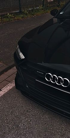 an audi car is parked on the side of the road