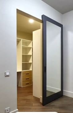 an empty room with a closet and mirror