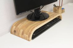 a computer monitor sitting on top of a wooden desk next to a keyboard and mouse