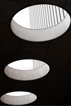 three circular windows in the ceiling of a building