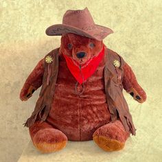 a brown teddy bear wearing a cowboy hat