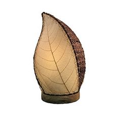 a light that is on top of a wooden stand with a leaf shaped lamp shade