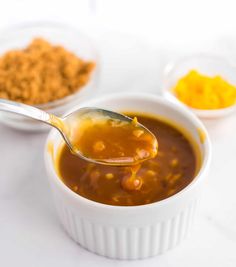 a spoon full of soup is being held up