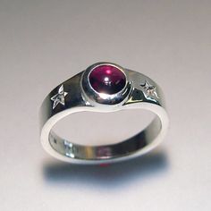 Two special stars, and an almandine garnet cabachon are the focal point on this hand carved, and cast, fun ring! The garnet measures 6mm, and is a beautiful raspberry color. It is bezel set, so there is no need to worry about prongs catching. This ring is sterling silver. This ring is made to order. Thanks for looking! Chris Celestial Ring, Star Garnet, Almandine Garnet, Indie Jewelry, Raspberry Color, Dope Jewelry, Jewelry Lookbook, Funky Jewelry, Garnet Ring