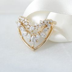 a diamond ring sitting on top of a white cloth