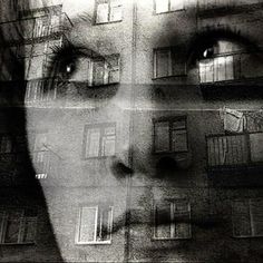 a woman's face with windows and balconies in the background