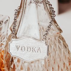 a vodka bottle with the word vodka engraved on it's front and back side