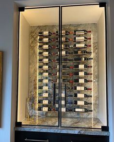 a glass case with bottles of wine in it