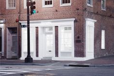 an empty street corner in front of a brick building