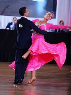 a man and woman dancing on a dance floor