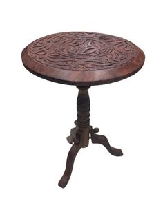 a wooden table with an intricate design on it's top and two small legs