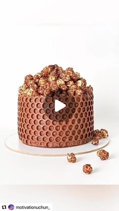 a chocolate cake with lots of nuts on the side and a video player in the middle