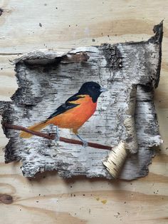 a piece of wood with a bird painted on it