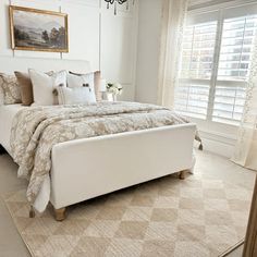 a bedroom with a large bed and chandelier