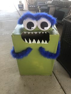 a cardboard box that has a monster face on it