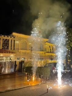 fireworks are lit up in front of a building