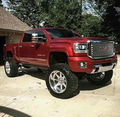 a red truck parked in front of a garage