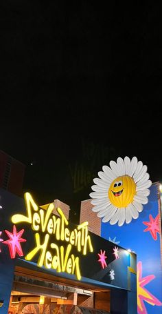 the neon sign for seventh heaven is lit up at night