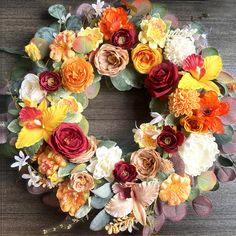 a wreath made out of flowers on top of a wooden table