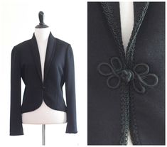 "Vintage black knit blazer from the 1960s or 70s. It features a shawl collar with black corded trim, small shoulder pads, and closes with a single frog button at the waist. The blazer is made from a comfortable, tight-knit fabric that drapes like a thick sweatshirt. Stylish and comfortable! MEASUREMENTS (laid flat; approximate): Shoulder: 15\"  Bust: 38\"  Waist: 35\"  Length: 20\"  Sleeve: 23\"  Underarm sleeve: 17\" LABEL: Butte; ILGWU Era: 1960s or 70s Color: Black Collar: Shawl collar with black corded trim Closure: One frog button at the waist Shoulder Pads: Small shoulder pads for structure Fabric: Tight knitwear with a comfortable, sweatshirt-like drape Origin: Union made in the USA Pleast contact me with any questions you have! NOTE ON FIT:  Measurements are taken across item layin Blouson Dress, Knit Blazer, Womens Blazers, The 1960s, Black Knit, Shawl Collar, Two Piece Outfit, Blazer Suit, Vintage Black