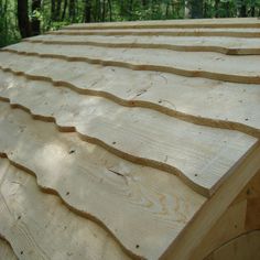 wooden boards stacked on top of each other in the woods