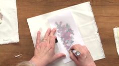 an older woman is working on some paper