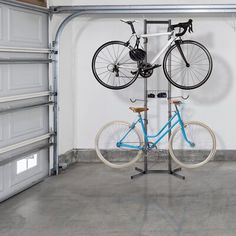 two bicycles mounted to a pole in a garage