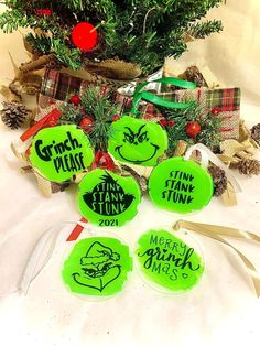 some green frisbees sitting next to a christmas tree