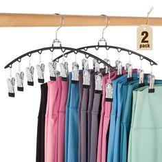 there are many different colored umbrellas hanging on the rack and two hangers attached to each other