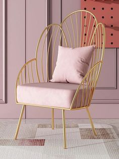 a pink and gold chair sitting on top of a rug