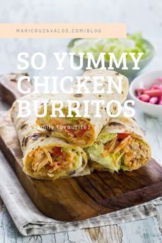 a chicken burrito cut in half on a cutting board