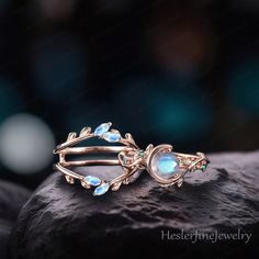 a gold ring with blue stones and leaves