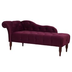 a purple couch sitting on top of a white floor