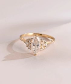 a gold ring with two pear shaped diamonds