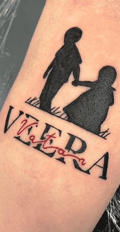 a tattoo on the leg of a person with an image of a man and woman