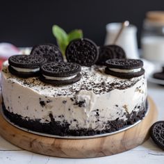 an oreo cookie cake with cream frosting and cookies on the top is ready to be eaten