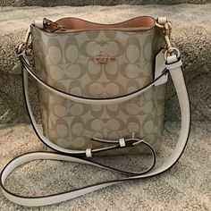 Coach Mollie Bag 22 In Signature Canvas Center Zip Compartment Snap Closure Brand New! Cream Bucket Satchel With Detachable Strap, Cream Bucket Bag With Detachable Strap For Errands, Luxury White Pouch Shoulder Bag, Luxury White Pouch Satchel, Chic White Pouch Satchel, Modern White Bucket Bag With Gold-tone Hardware, Coach Beige Shoulder Bag With Dust Bag, Beige Coach Shoulder Bag With Dust Bag, White Rectangular Bucket Bag With Gold-tone Hardware