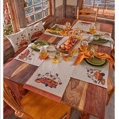 the table is set with place settings for two people to enjoy their thanksgiving feasts